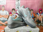 Nike Gray Low-Top Sneakers with Metallic Swoosh